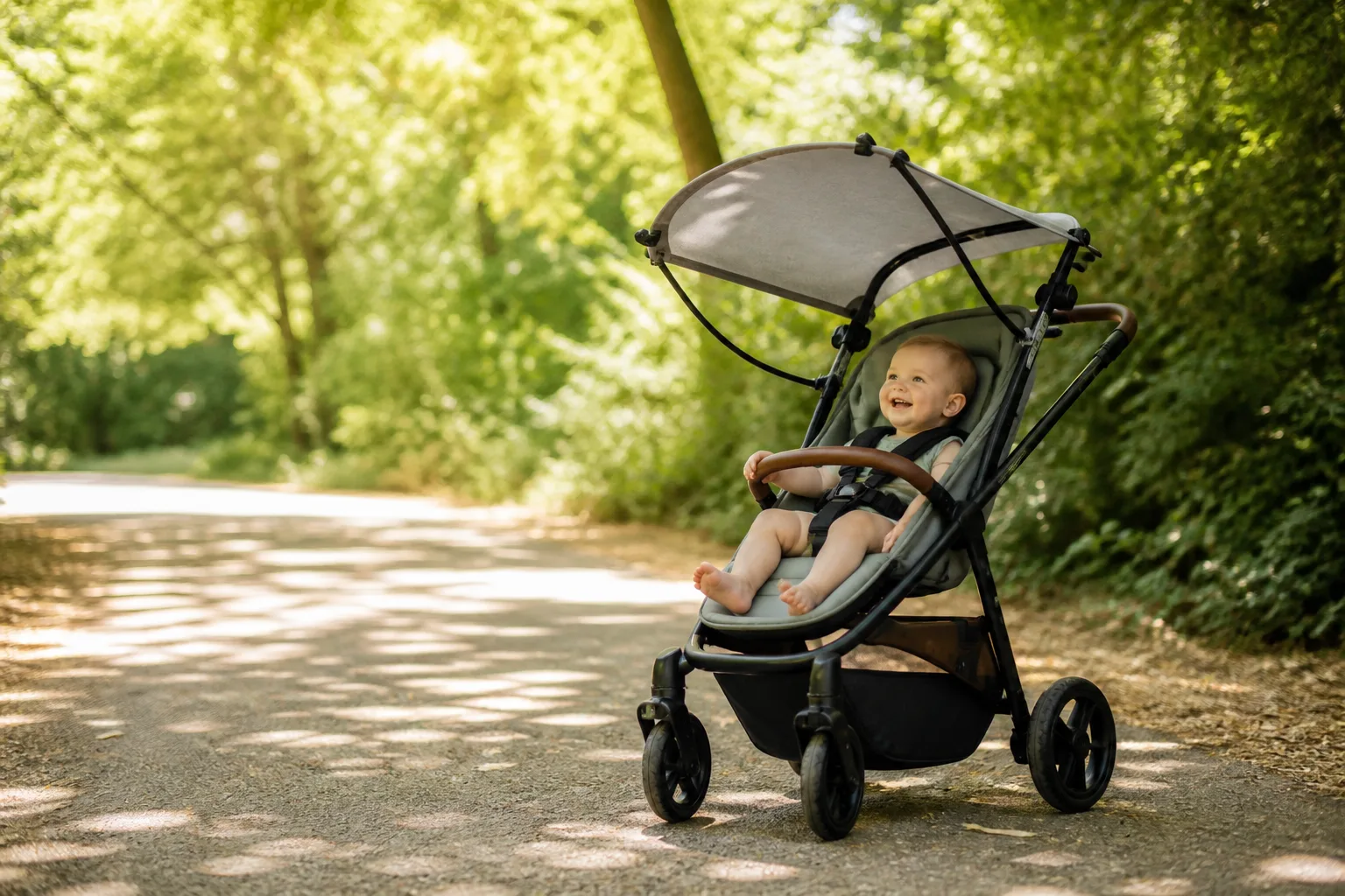 A stroller in summer shade with a clip-on sunshade arched over the fully open seat, air moving freely through it, no blanket anywhere in sight