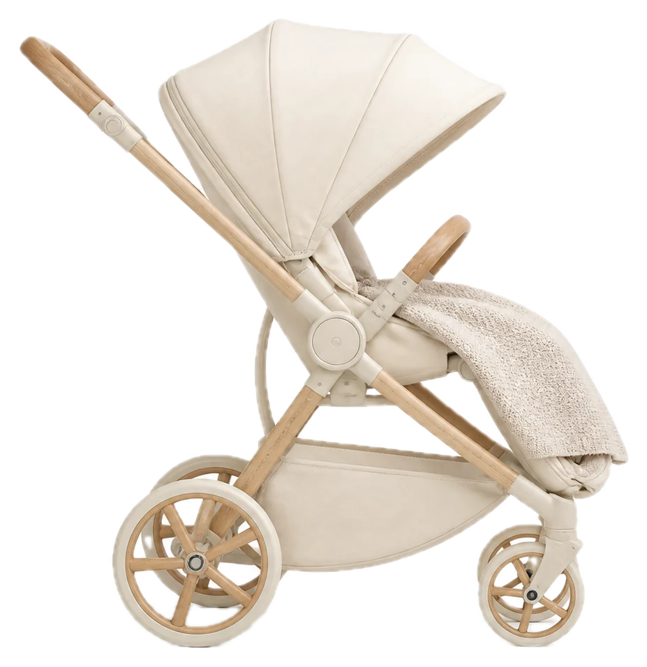 A cream stroller in profile with a knit blanket tucked only over the leg area